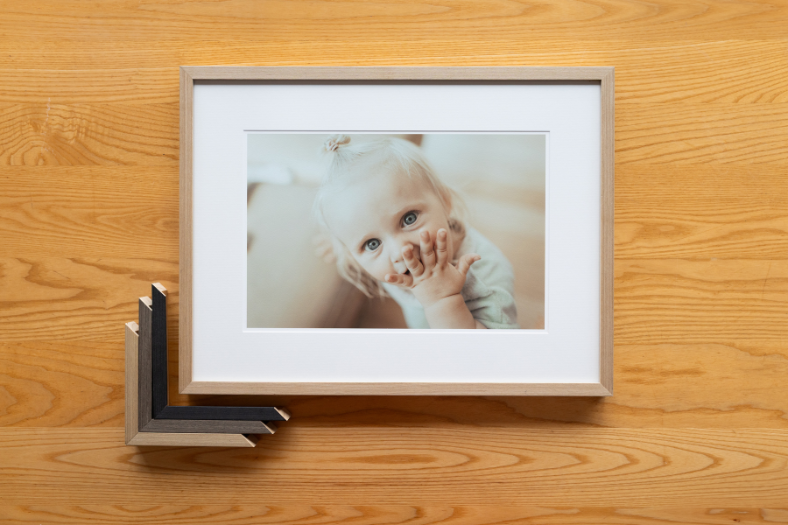 Framed family portrait by Muka Portraits enhancing interior design – a result of small business collaboration.